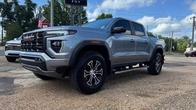 2024 GMC Canyon AT4 in Sterling Metallic — front three-quarter view